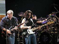 peart right behind alex lifeson geddy lee performing with rush